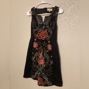 Moulinette Soeurs Black Dress with Vibrant Floral Embroidery